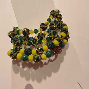 A collection of green and yellow beaded sparkly stretchy bracelets with sparkly football beads